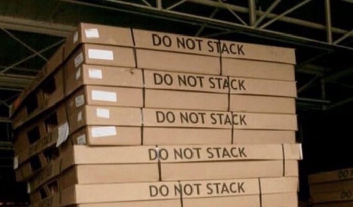 Work instructions apparently unclear. A bunch of pallets stacked together, despite "DO NOT STACK" clearly written on them.